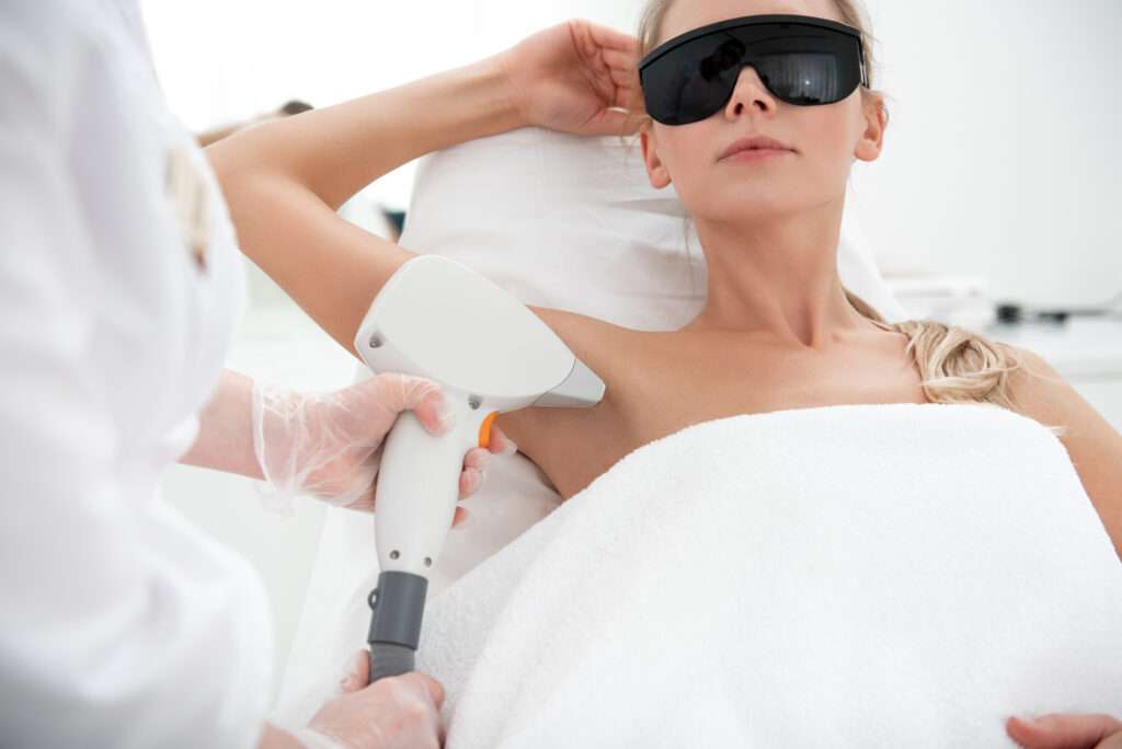 Serene girl during depilation of armpit