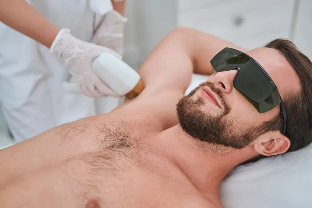 man receiving armpit hair laser removal treatment